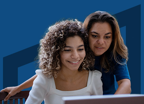 mom and daughter in front of laptop on dark blue background.