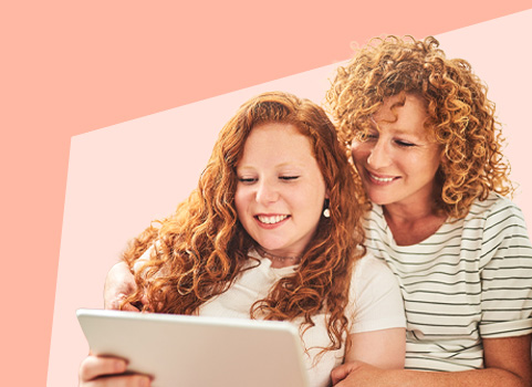 Mom and daughter looking at a tablet together.