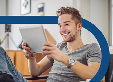 Man in grey t-shirt holding tablet.