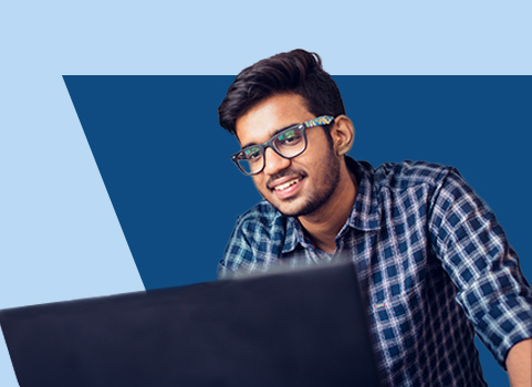 Man in blue shirt with glasses using laptop.