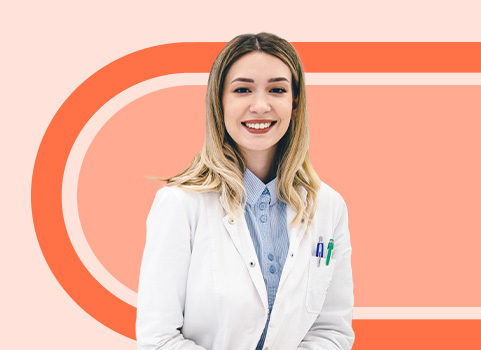 pharmacy technician in white coat on orange background.